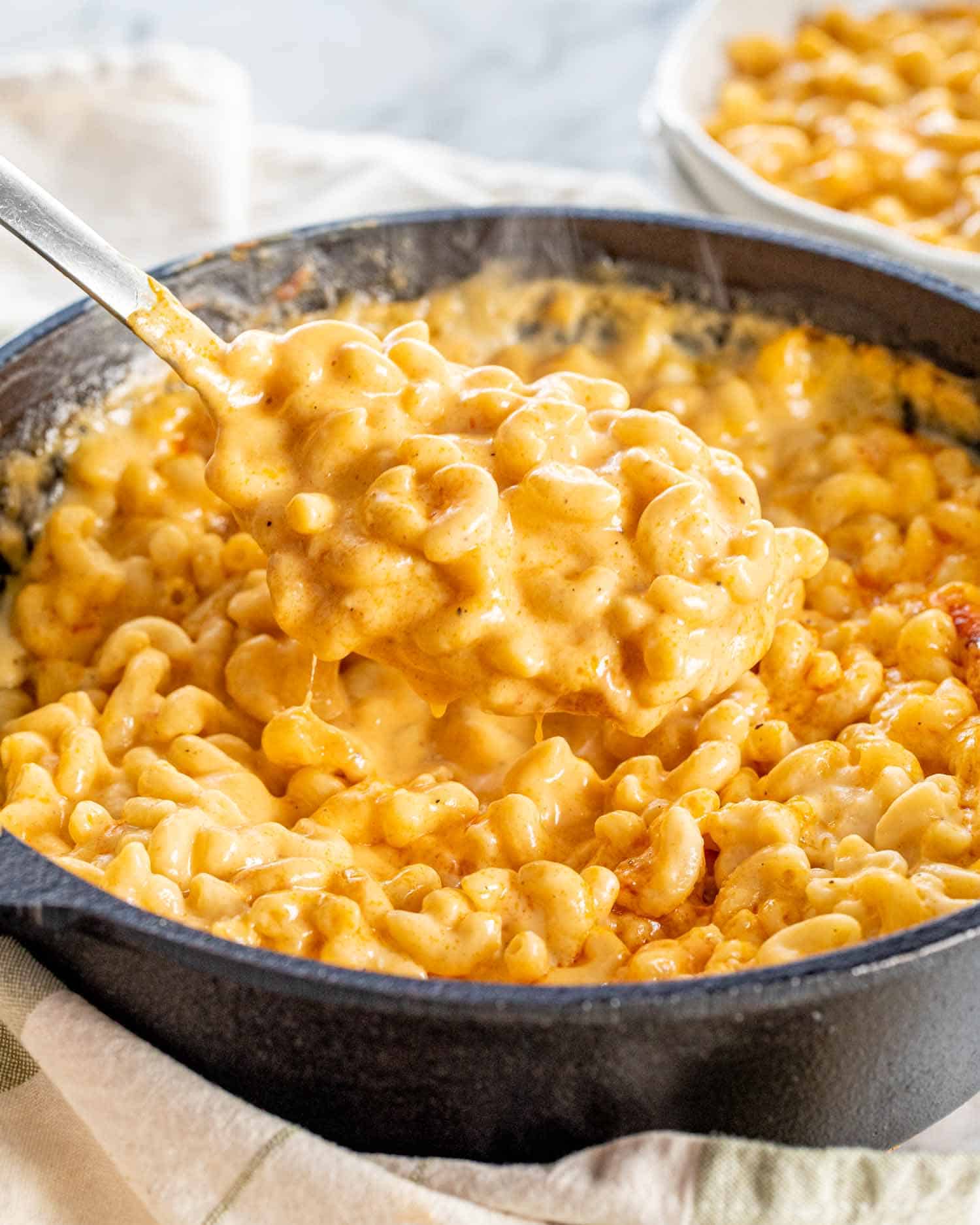baked mac and cheese in a black cast iron skillet.