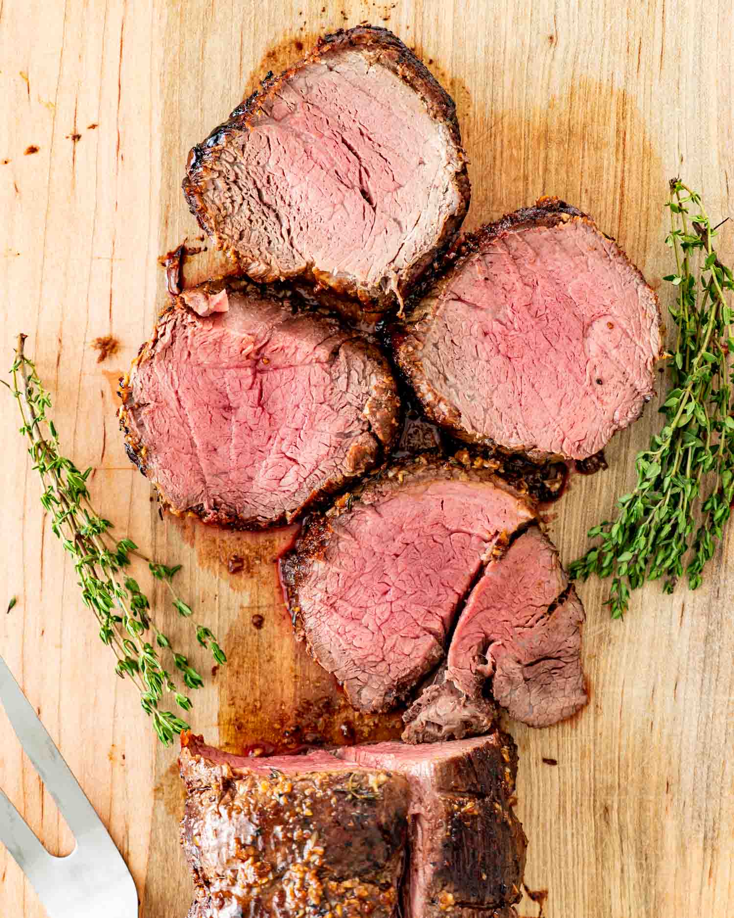 beef tenderloin sliced on a cutting board.