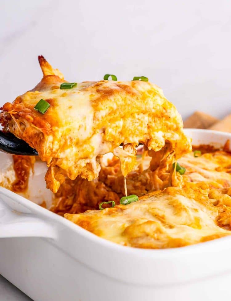 freshly baked 4 ingredient chicken enchilada casserole in a white casserole dish.