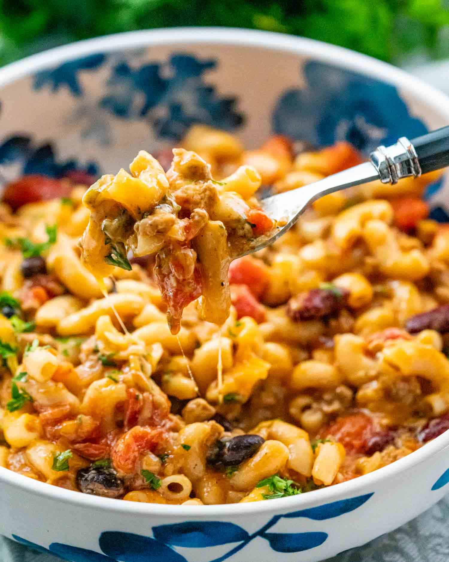 a serving of chili mac and cheese in a white bowl.