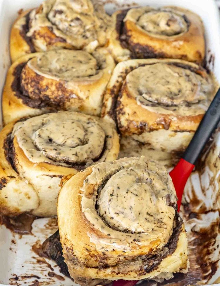 freshly made chocolate espresso rolls in a baking dish with espresso icing.