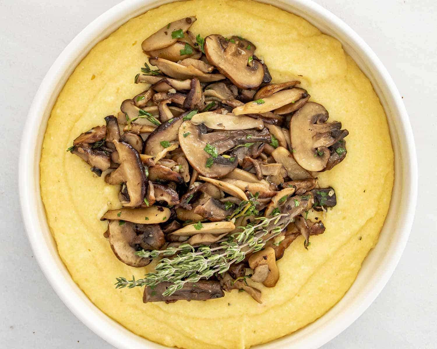process shots showing how to make creamy parmesan polenta with mushrooms.