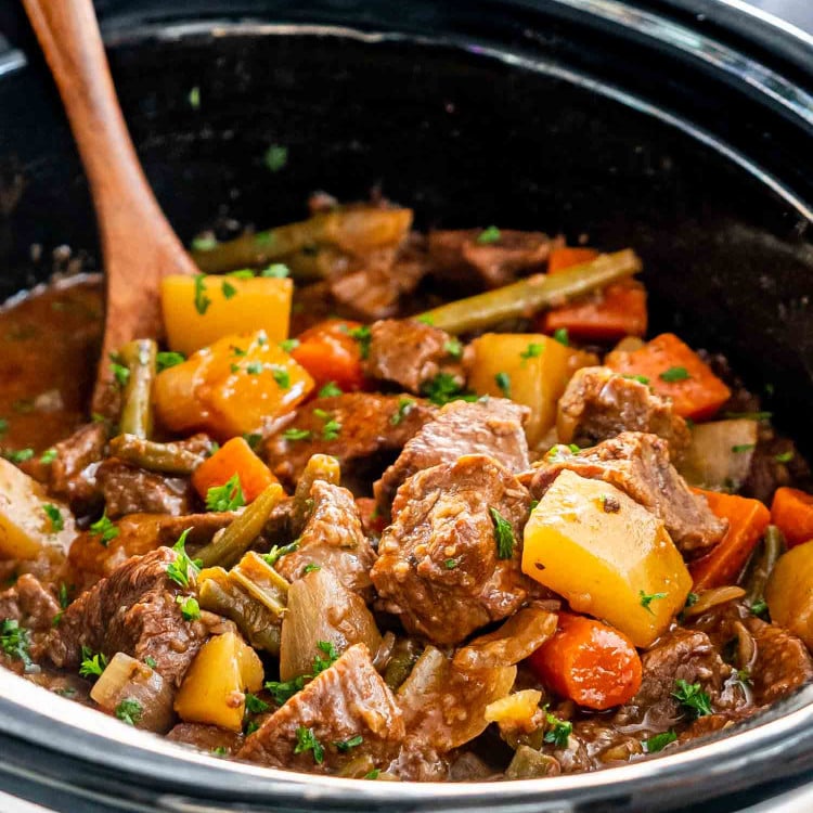 beef stew in a black crockpot.