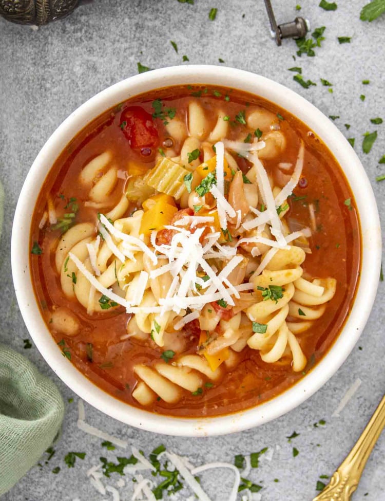 A bowl of Instant Pot Pasta e Fagioli, packed with rotini pasta, beans, and vegetables in a rich tomato broth.