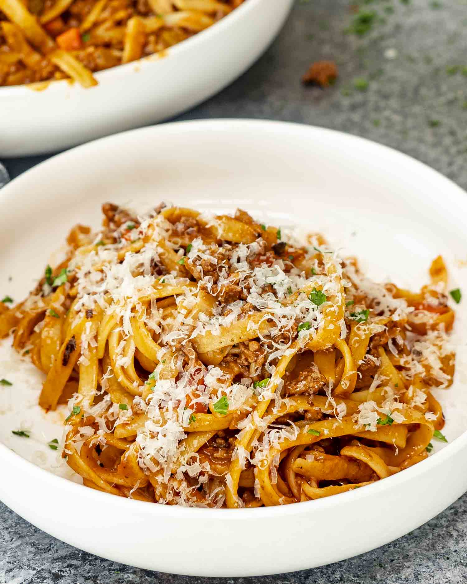 a serving of beef ragu pasta in a white bowl.