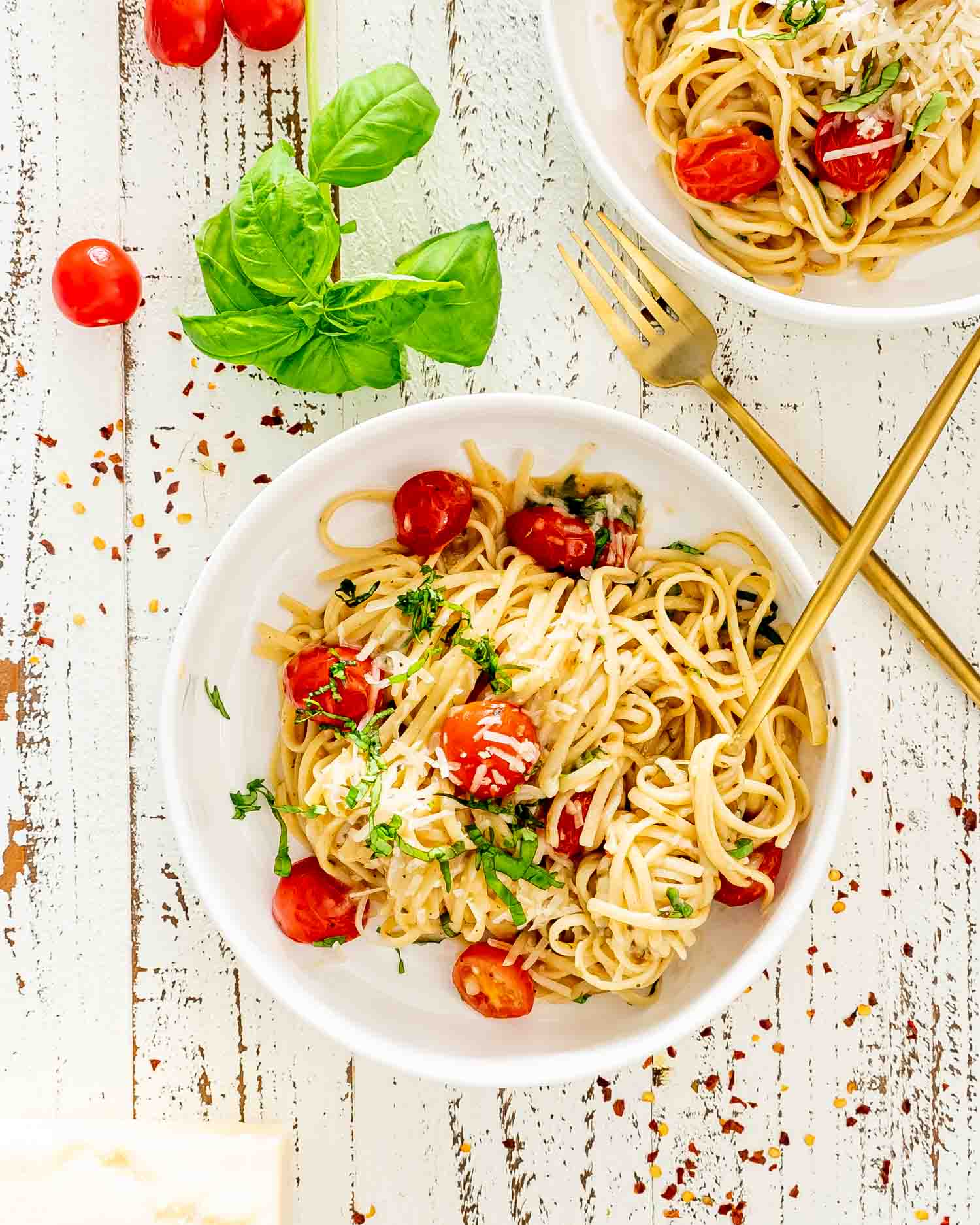 freshly made one pot pasta in white bowls garnished with basil.