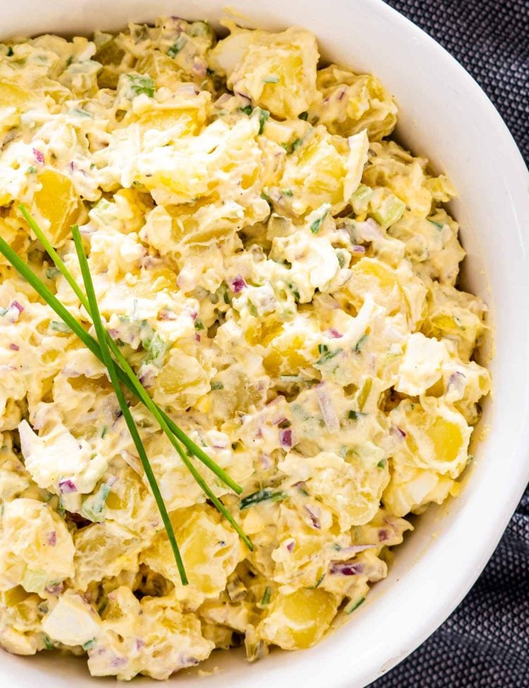 close up of potato salad in a white bowl.