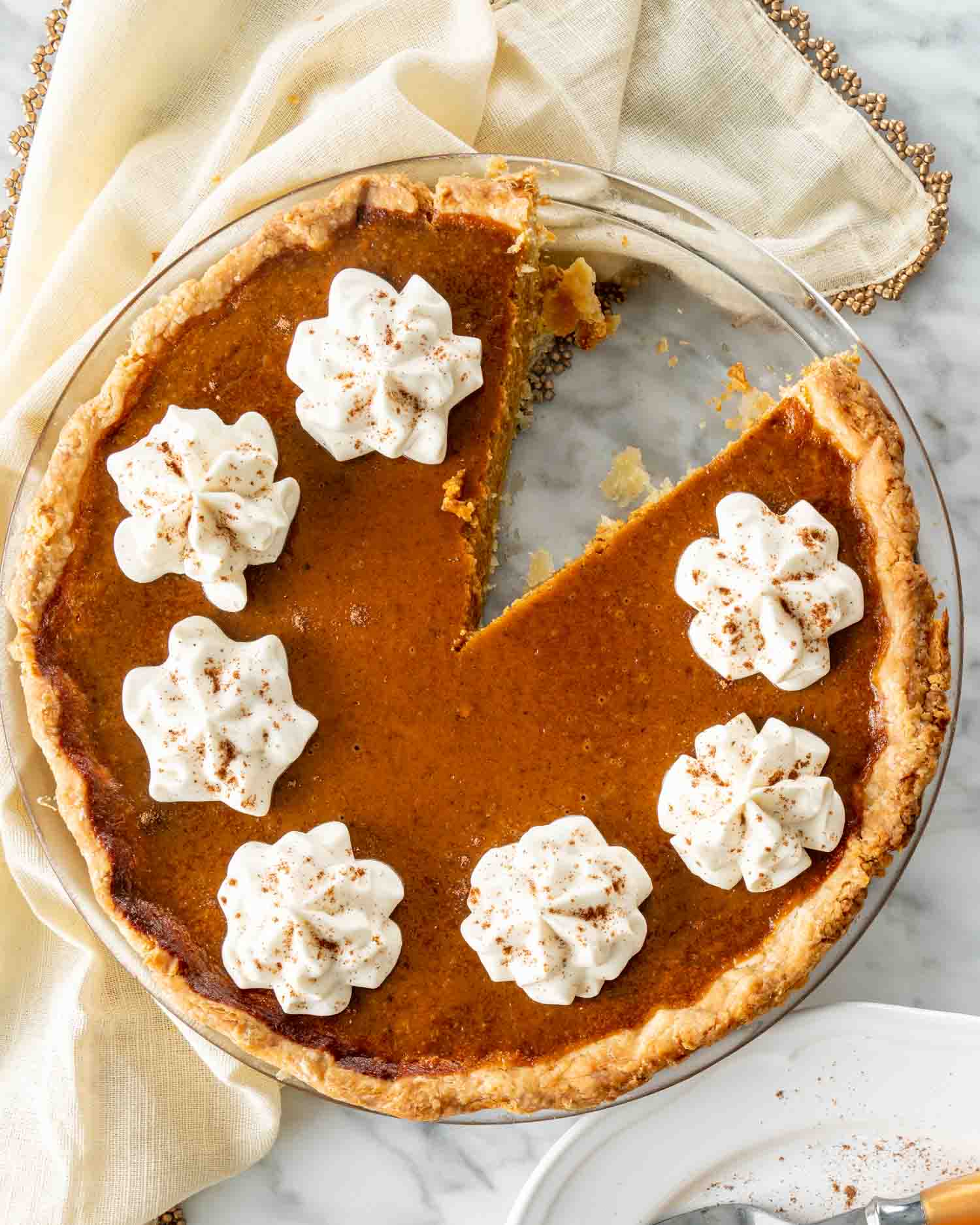 a freshly baked pumpkin pie with whipped cream.
