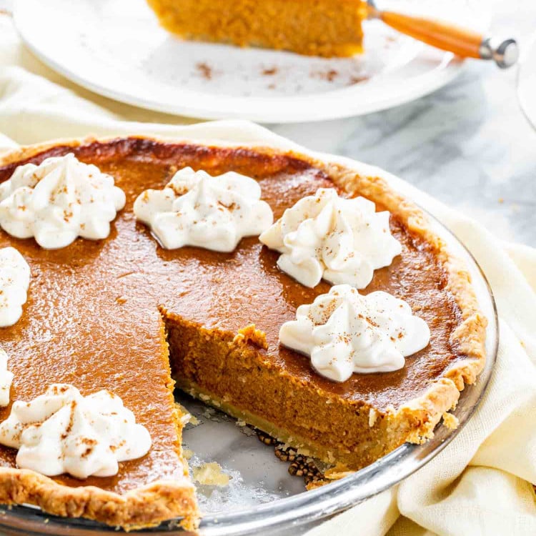 a freshly baked pumpkin pie with whipped cream.
