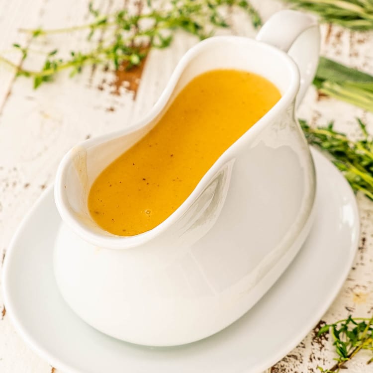 a gorgeous white gravy bowl with turkey gravy.